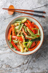 Summer Stir fry zucchini, green onions and bell pepper close-up in a bowl on the table. Vertical top view from above