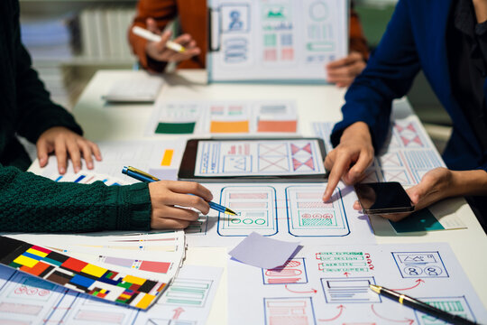 UX developer and ui designer brainstorming about mobile app interface wireframe design with customer breif and color code, User experience concept..