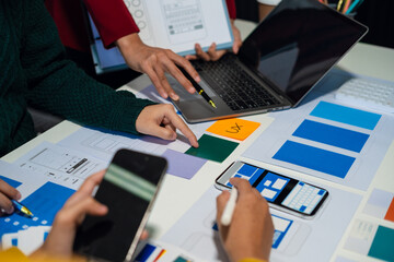 UX developer and ui designer brainstorming about mobile app interface wireframe design with...