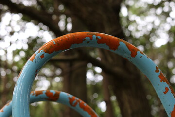 Slide handle with blue paint peeled off and orange substrate exposed