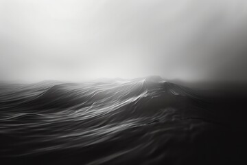 Abstract black and white image of a mountainous landscape shrouded in mist.