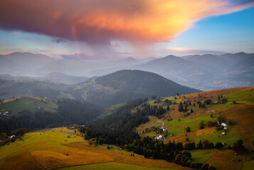 Fantastic rustic scene with green rolling hills from a bird's eye view. Carpathian mountains, Ukraine.