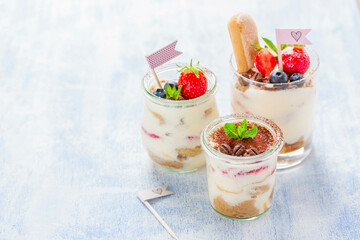 Homemade Italian Dessert Tiramisu With Strawberries, Mint And Cocoa In Glass Jars, Closeup