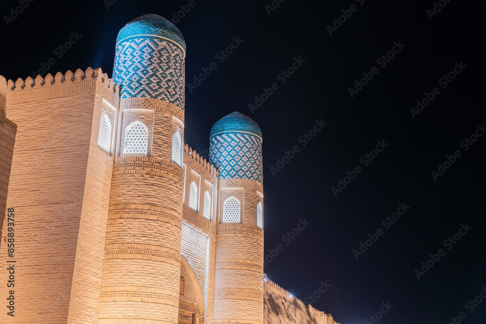 Wall mural a large building with blue domes and a white brick facade. the building is lit up at night