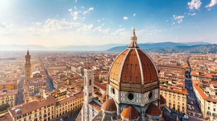 Fototapeta premium Aerial view of the Florence Cathedral and the surrounding cityscape under a clear blue sky, capturing the historic architecture and scenic landscape.