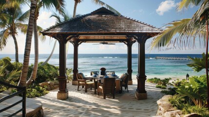 Fototapeta premium A beachside pavilion with a table and chairs, overlooking the ocean. The pavilion is shaded by a roof, and there are palm trees in the background. The scene is peaceful and relaxing
