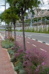Mediterranean Spanish city urban infrastructure - cars and bicycle roads, landscaping, and the pedestrian path and promenade along the sea