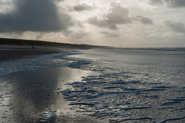 Clouds reflecting in a residu of water on the Beach near Egmond aan Zeen in North Holland, the Netherlands.