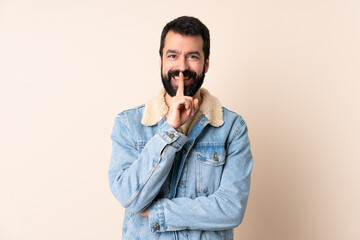 Caucasian man with beard over isolated background showing a sign of silence gesture putting finger in mouth
