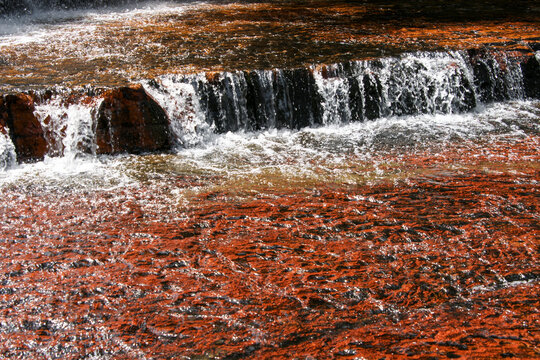 Red jasper gemstone riverbed and waterfall at Jasper Creek, Quebrada de Jaspe, Gran Sabana, Venezuela