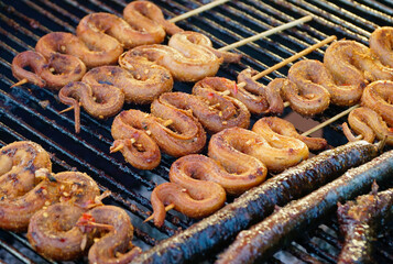 Close-up of grilled snakes on skewers