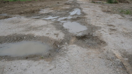 Ground after rain. Irregular space with puddles of swamp