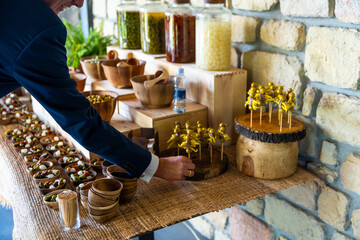 A man is standing in front of a table with a variety of food items