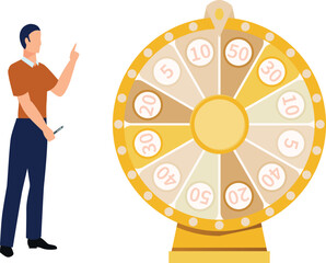 Boy is pointing at roulette wheel in casino.