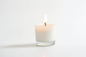 Single White Candle Burning in Glass Jar on White Background