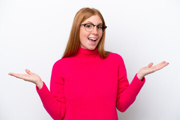 Young redhead woman isolated on white background with shocked facial expression