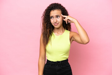 Young hispanic woman isolated on pink background making the gesture of madness putting finger on the head