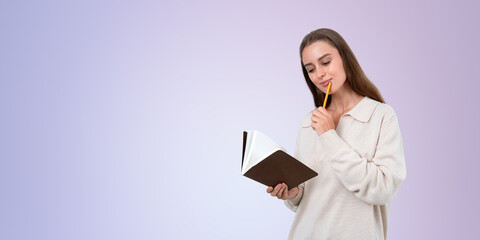 Woman holding a book and thinking with a pencil, on a light purp