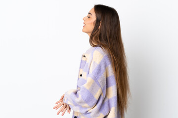 Young caucasian woman isolated on purple background laughing in lateral position
