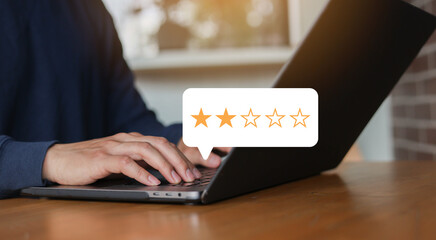 close up on customer man hand pressing two star (poor rating) feedback rank for give score point to...