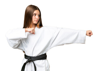 Teenager girl over isolated chroma key background doing karate © luismolinero