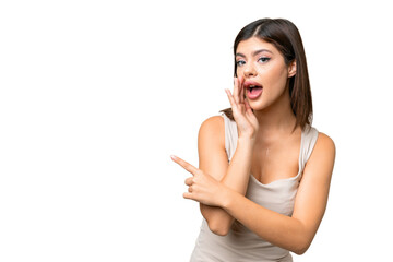 Young Russian woman over isolated chroma key background pointing to the side to present a product and whispering something