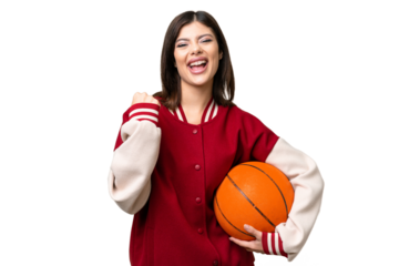 Young Russian woman playing basketball over isolated chroma key background celebrating a victory in winner position