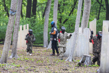 children playing paintball in the forest