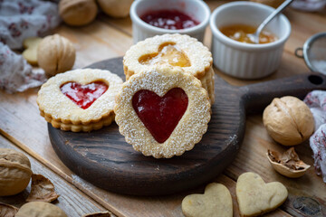 Romantic dessert: Austrian Linzer biscuits with strawberry jam for breakfast. Delicious cookies for Valentine's Day. Close-up
