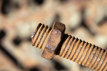 old rusty bolt, iron rod with screw threads. Rusted mechanical components. threaded bolt and nut...