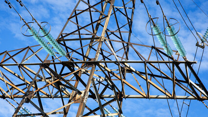 power line construction of cable supports and insulators. High voltage power line on blue sky...