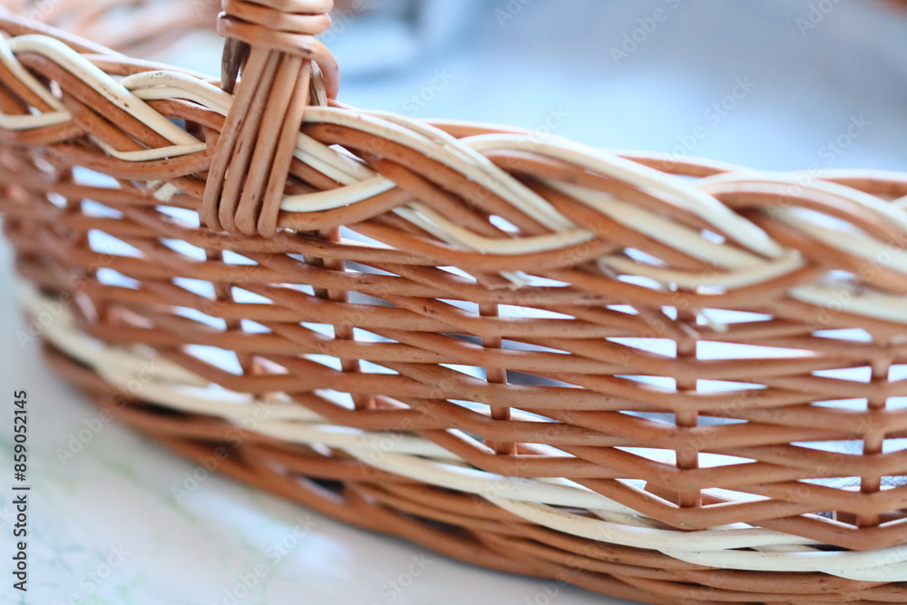 Poster A close-up of a wicker basket sitting on a table with various items inside
