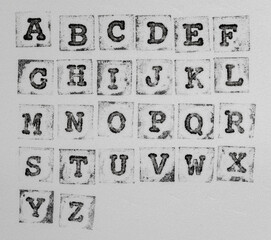 macro photo of real stamp abc on white foam background, alphabet elements for your social media...