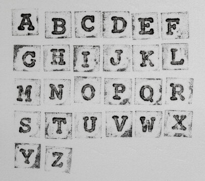 macro photo of real stamp abc on white foam background, alphabet elements for your social media font collage.