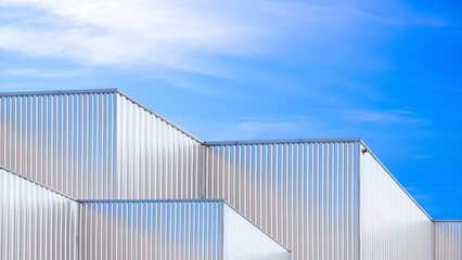 Group of industrial factory buildings with geometric pattern of aluminium corrugated steel wall...