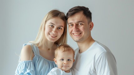 Happy Young Family Portrait With Baby In White Interior