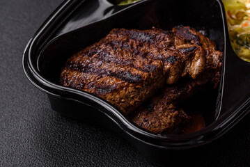 Fresh juicy delicious beef steak on a dark background