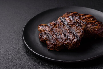 Fresh juicy delicious beef steak on a dark background