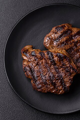 Fresh juicy delicious beef steak on a dark background