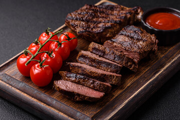 Fresh juicy delicious beef steak on a dark background