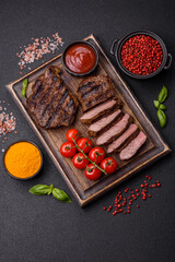 Fresh juicy delicious beef steak on a dark background