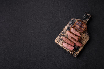 Fresh juicy delicious beef steak on a dark background