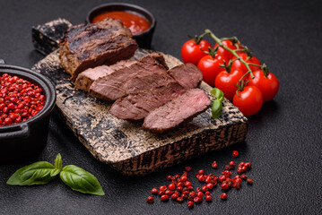 Fresh juicy delicious beef steak on a dark background