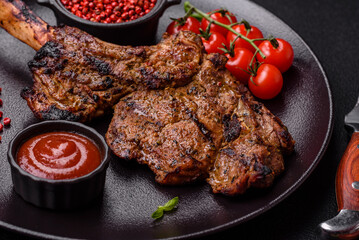 Juicy beef tomahawk steak on the bone baked on the grill