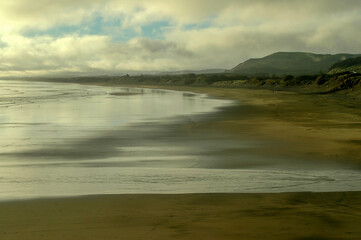 Strolling on the beach under the winter sun in New Zealand