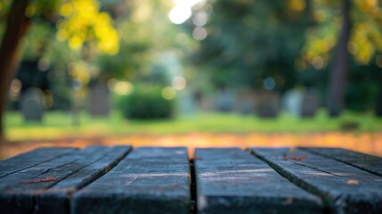 a close up of a empty wooden table with graveyard background