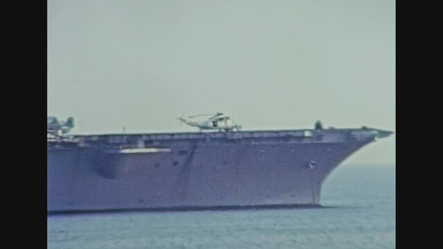 close up of USS carrier warships of United States Navy. Navigating in the port of Genova city in 1981. Archival of Italy in the 1980s with Genova Italian harbor.