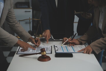 Judge gavel with Justice lawyers having team meeting at law firm background. Concepts of Law and...