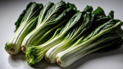 bunch of bokchoy on white table and plain background with dramatic lighting