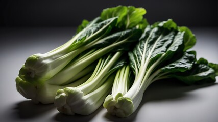 bunch of bokchoy on white table and plain background with dramatic lighting